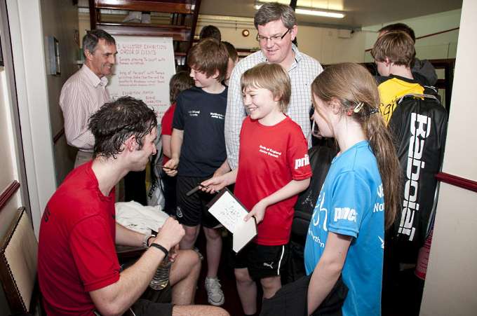 Eddie Charlton signing autographs for the Juniors